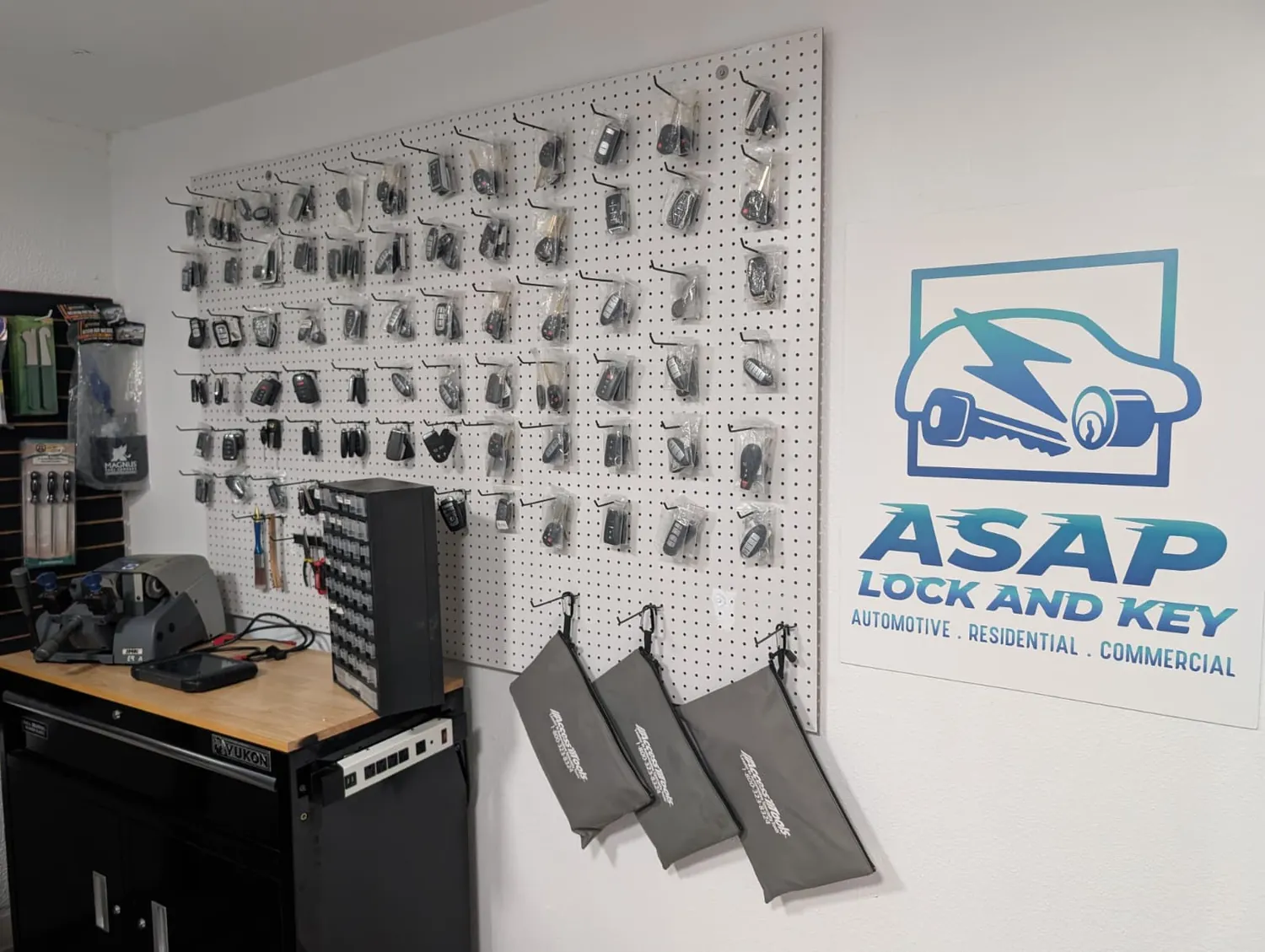 Automotive key fobs displayed on the shop wall